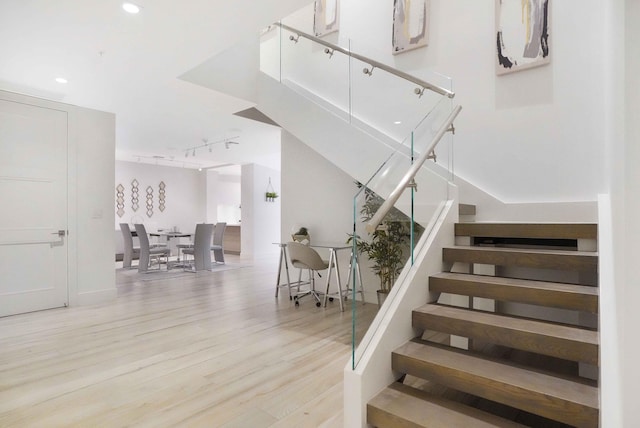 stairs featuring hardwood / wood-style flooring