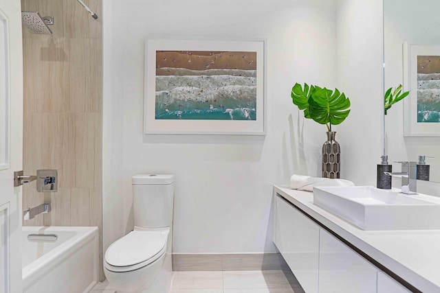 full bathroom featuring vanity, tiled shower / bath combo, toilet, and tile patterned floors