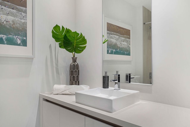 bathroom featuring vanity and toilet