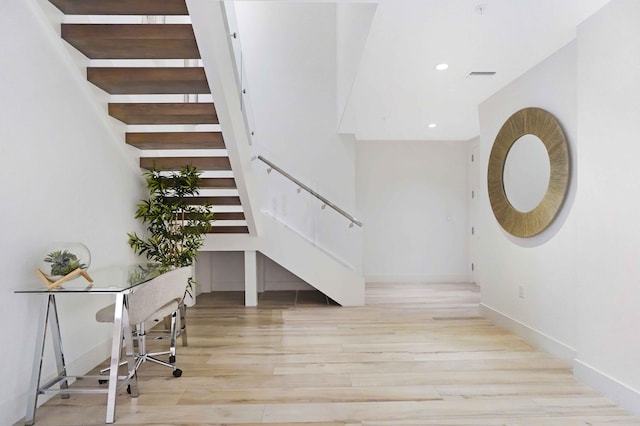 stairs featuring wood-type flooring