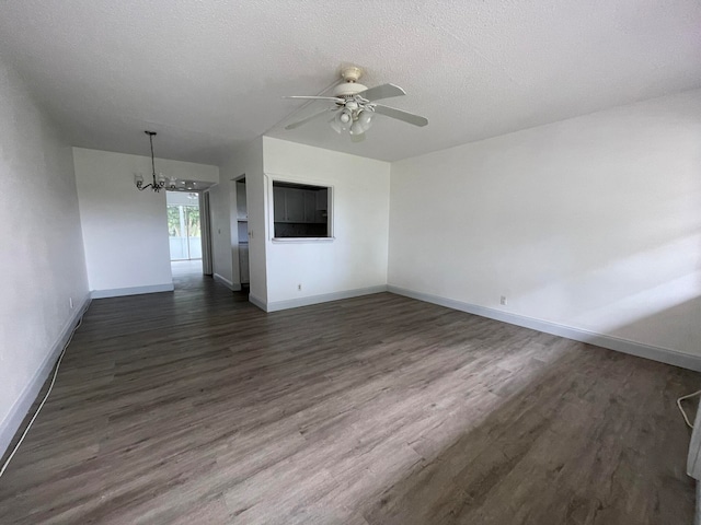 unfurnished room with a textured ceiling, dark hardwood / wood-style floors, and ceiling fan with notable chandelier