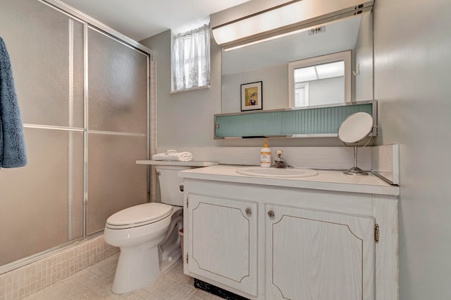 bathroom featuring walk in shower, tile flooring, large vanity, and toilet