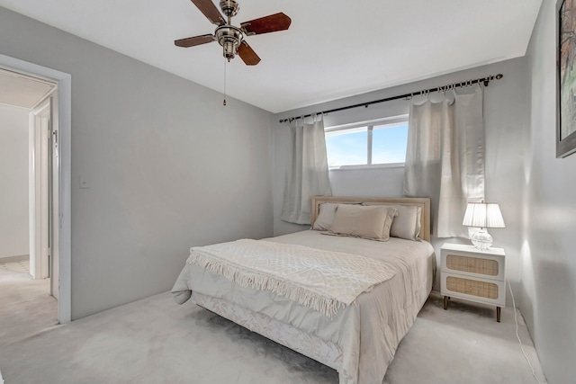 bedroom with light carpet and ceiling fan