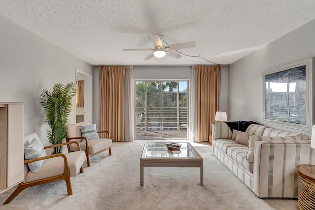 living room featuring light carpet, a textured ceiling, and ceiling fan