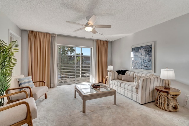 living room featuring light carpet, a textured ceiling, and ceiling fan