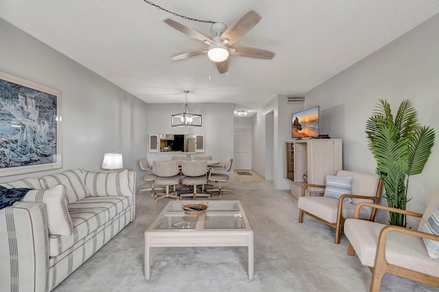 carpeted living room featuring ceiling fan with notable chandelier