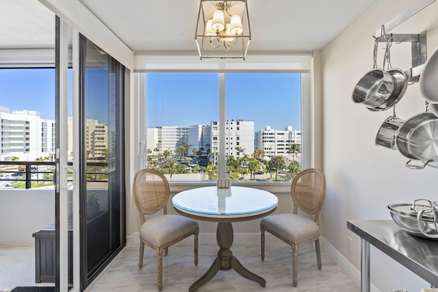 dining space with a notable chandelier and a healthy amount of sunlight