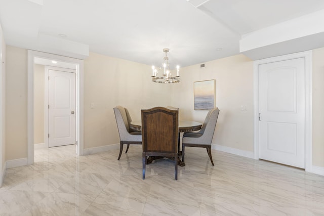 dining room with a chandelier and light tile flooring