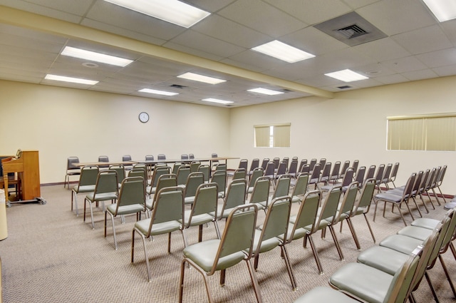 carpeted cinema with a drop ceiling