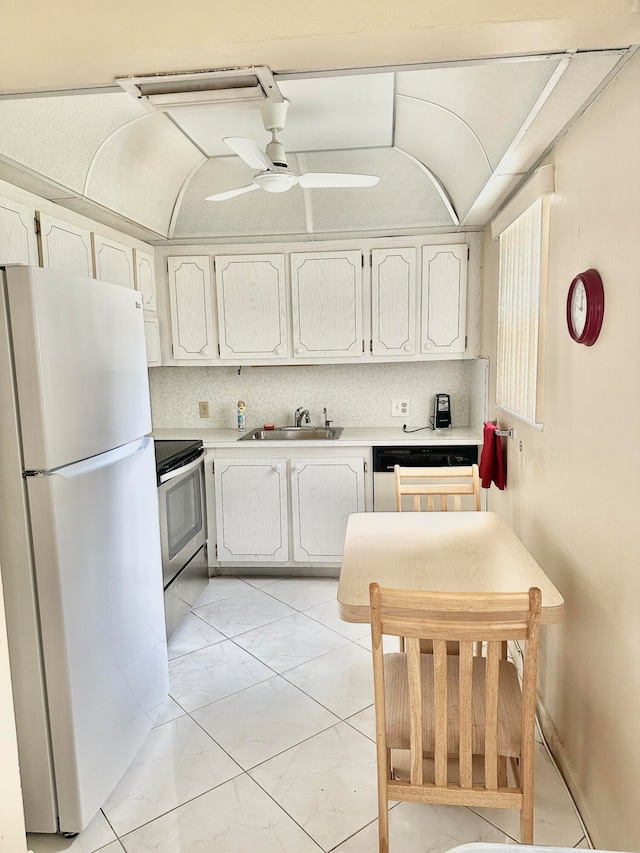 kitchen with white refrigerator, range with electric cooktop, ceiling fan, dishwashing machine, and sink