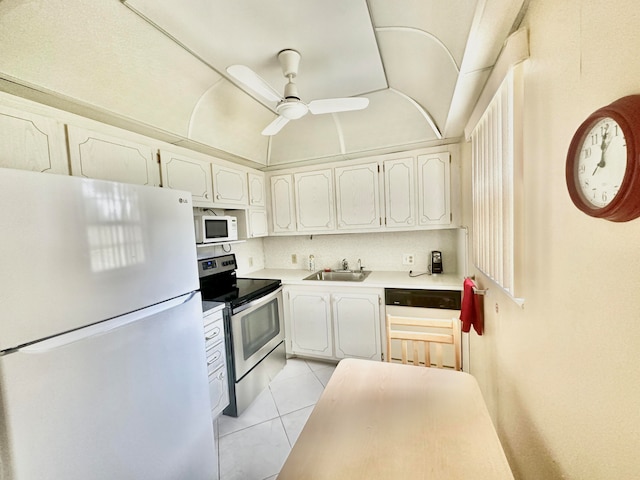 kitchen with light tile floors, ceiling fan, white appliances, white cabinetry, and sink