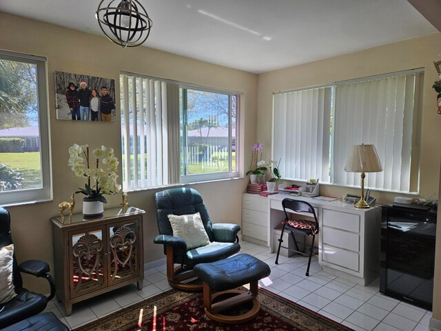 sitting room with a chandelier and light tile floors