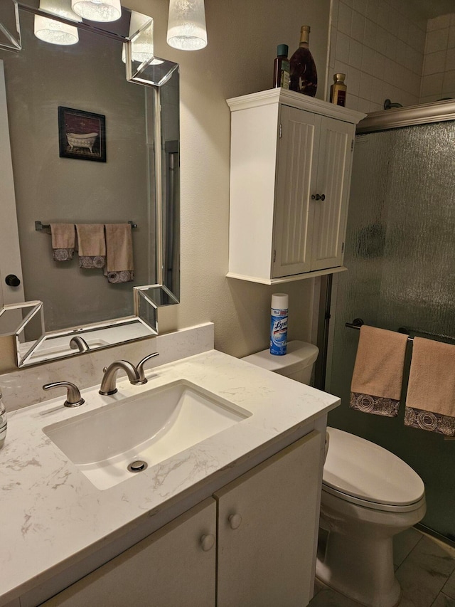 bathroom with toilet, tile floors, and large vanity