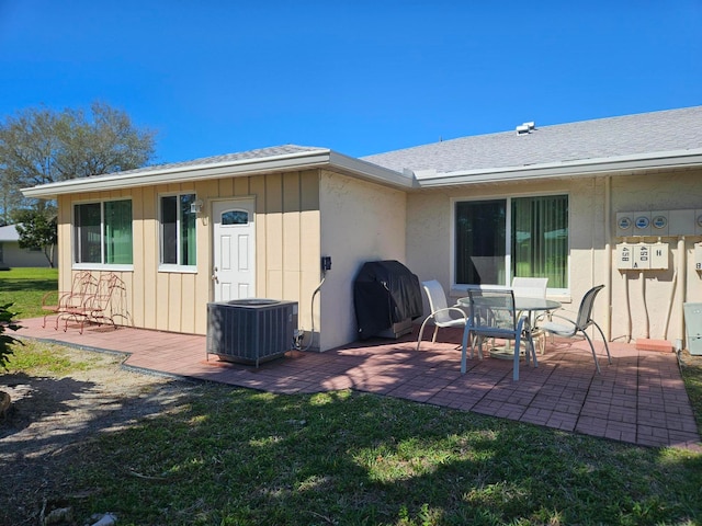 rear view of property with a patio area and central AC