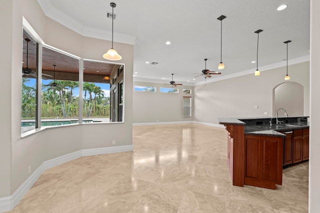 kitchen with hanging light fixtures, ceiling fan, sink, light tile floors, and dark stone counters