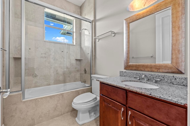 full bathroom featuring toilet, combined bath / shower with glass door, tile flooring, and vanity