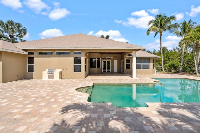 view of pool with a patio area and ceiling fan