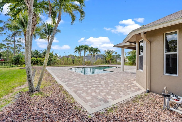 view of pool featuring a lawn and a patio area