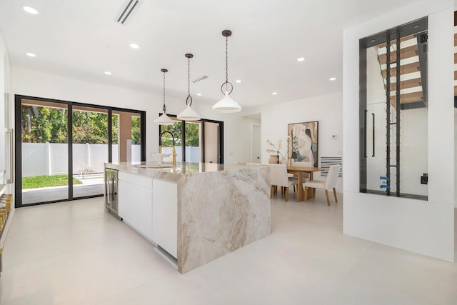 363 31st Ct, West Palm Beach, FL 33407 - kitchen with a sink, recessed lighting, white cabinets, modern cabinets, and a large island