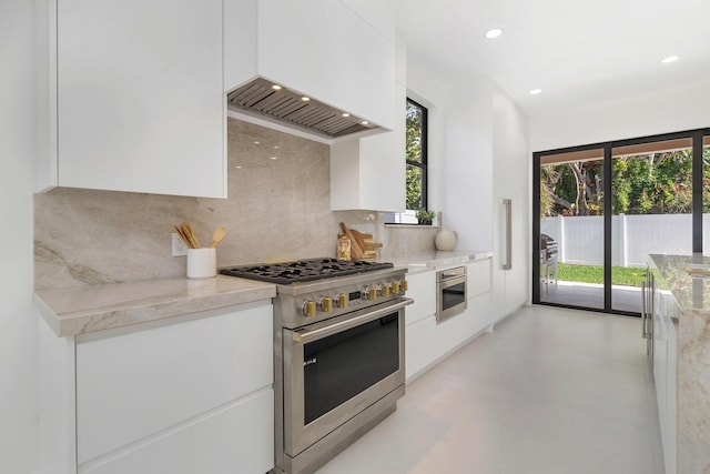 363 31st Ct, West Palm Beach, FL 33407 - kitchen with appliances with stainless steel finishes, modern cabinets, white cabinetry, tasteful backsplash, and plenty of natural light
