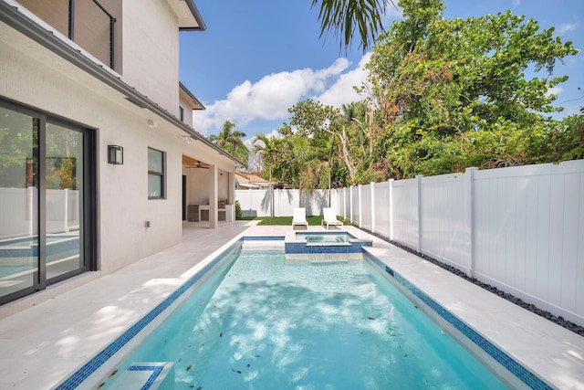 363 31st Ct, West Palm Beach, FL 33407 - view of swimming pool with a patio, a fenced backyard, a ceiling fan, and a pool with connected hot tub