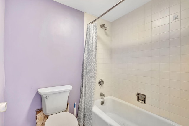 bathroom featuring shower / bath combination with curtain and toilet