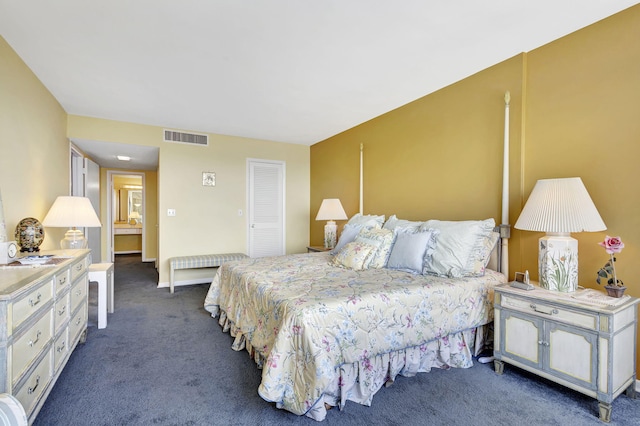 bedroom with a closet and dark colored carpet