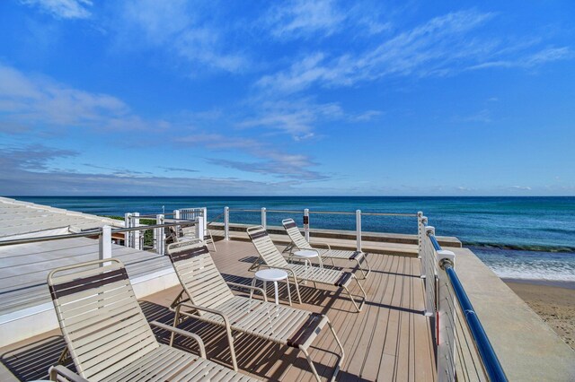 exterior space with a water view and a beach view