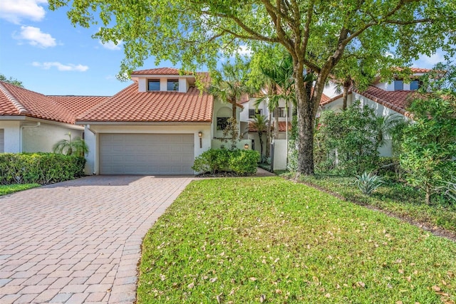 mediterranean / spanish home featuring a front yard