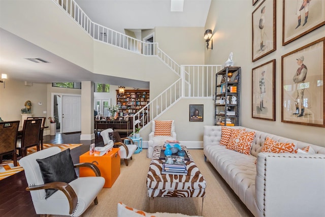 living room with a high ceiling and hardwood / wood-style flooring