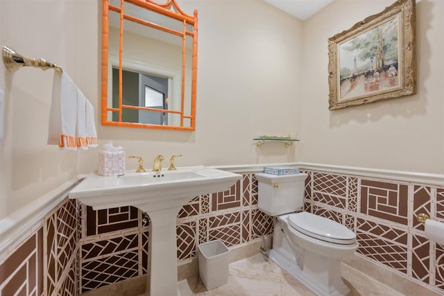 bathroom featuring toilet and tile floors