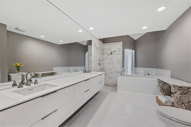 bathroom featuring toilet, a washtub, oversized vanity, dual sinks, and tile floors