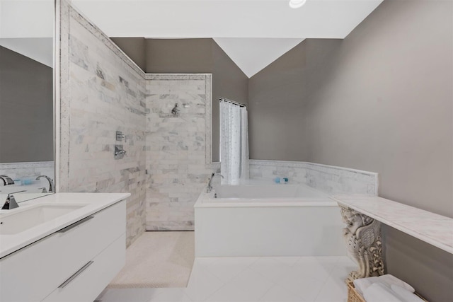 bathroom with vanity, a tub, tile floors, and vaulted ceiling