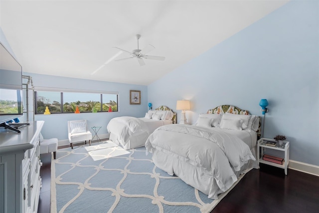 bedroom with vaulted ceiling, ceiling fan, and dark hardwood / wood-style flooring