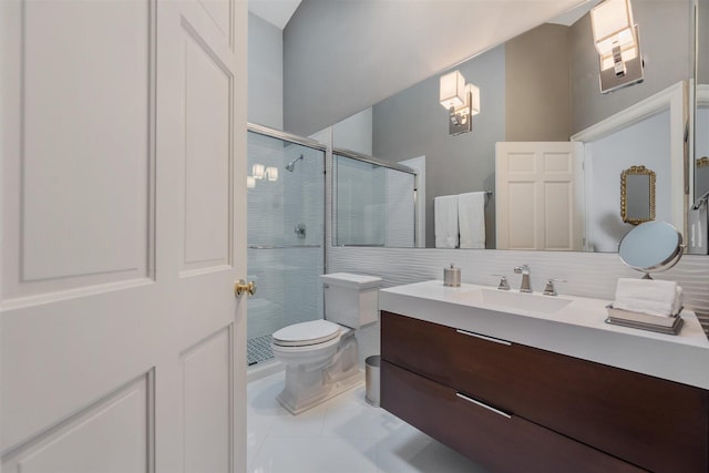 bathroom with a shower with shower door, tile flooring, large vanity, and toilet