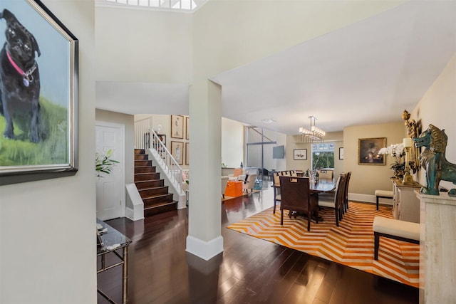 interior space with an inviting chandelier and dark hardwood / wood-style floors