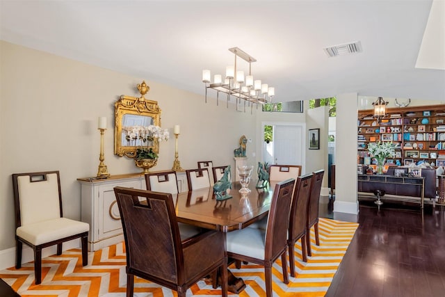 dining area featuring an inviting chandelier and hardwood / wood-style floors