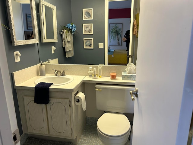 bathroom with toilet and large vanity