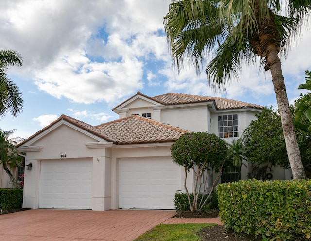 mediterranean / spanish-style home with a garage