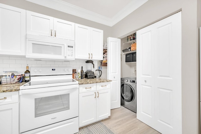 kitchen featuring dishwasher, stone counters, a sink, and white cabinetry