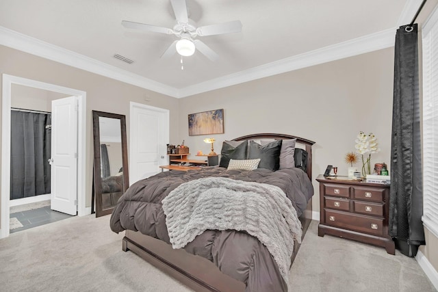 bedroom featuring ornamental molding, visible vents, ceiling fan, and light carpet