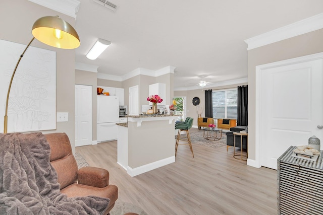 kitchen with light hardwood / wood-style flooring, white cabinetry, white fridge, kitchen peninsula, and crown molding