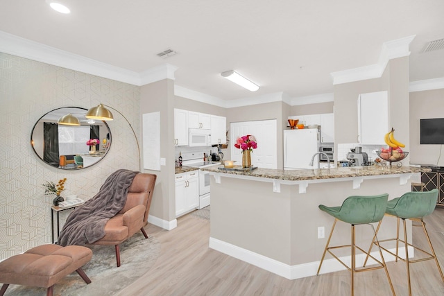 living area featuring ornamental molding and light wood-type flooring