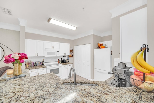 kitchen featuring visible vents, white cabinetry, light stone countertops, light wood-type flooring, and white appliances