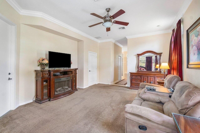 living room featuring ceiling fan, crown molding, and carpet floors