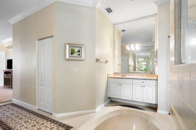 bathroom featuring tile patterned floors, crown molding, and vanity