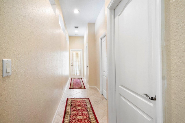 hallway with light tile patterned floors