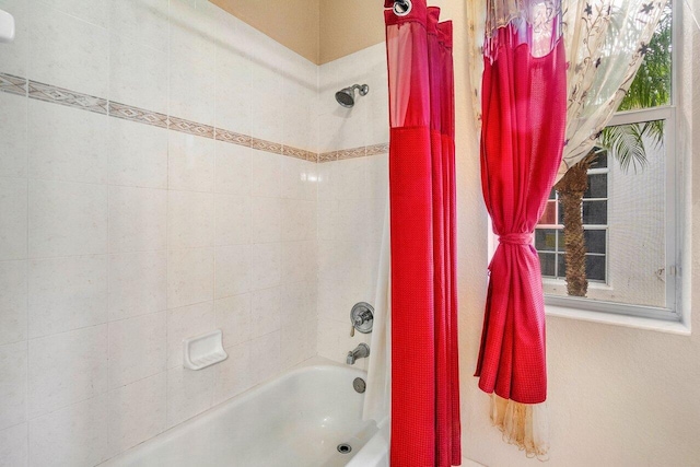 bathroom with shower / bath combination with curtain