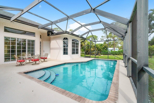 view of pool with a lanai and a patio area