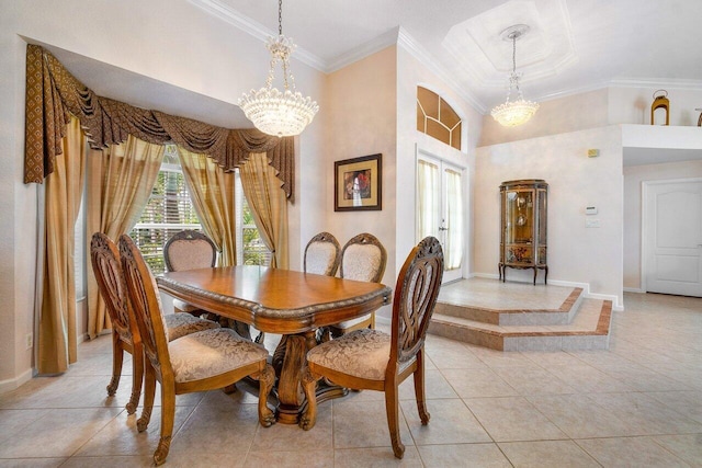 tiled dining space featuring ornamental molding and an inviting chandelier